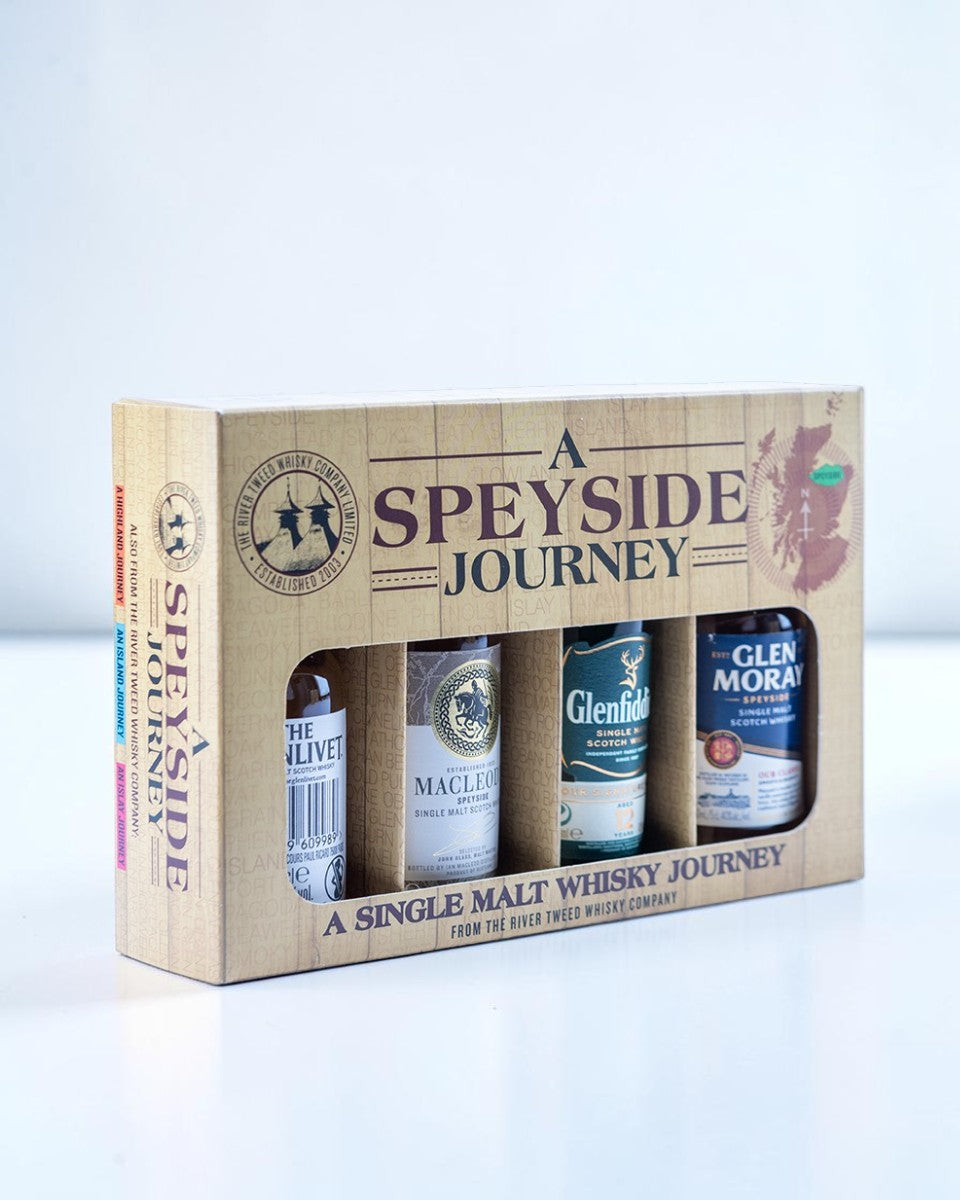 A Speyside Journey single malt whisky gift set in a light wood-textured box, containing four bottles.