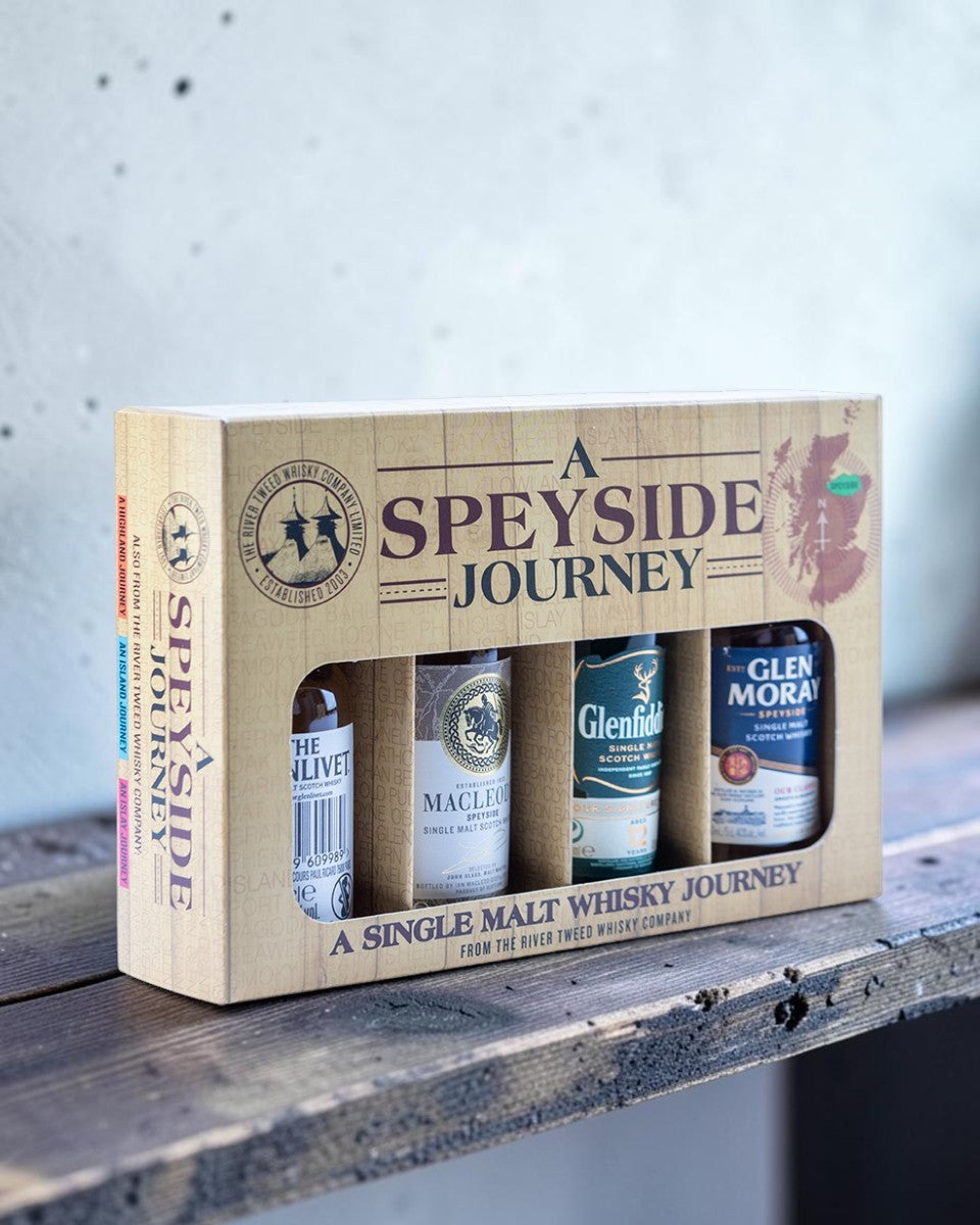 A Speyside Journey single malt whisky gift set in a light wood-textured box, containing four bottles.